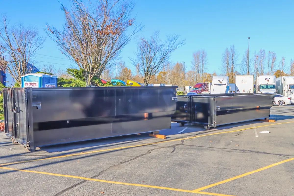 Professional dumpster rental service with roll-off container on residential driveway in Endicott